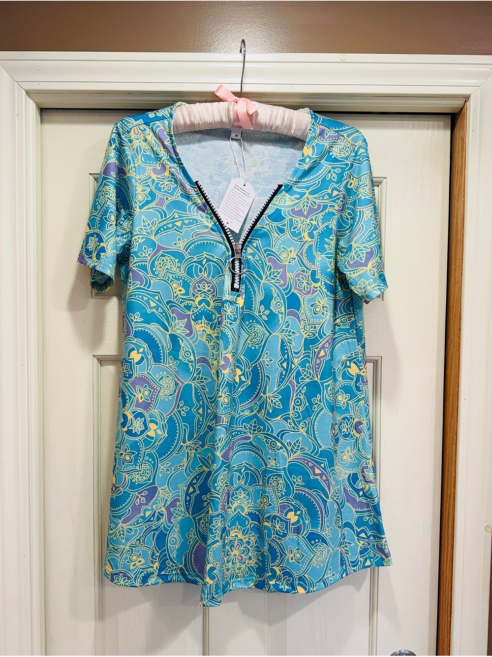 Blue Patterned V-Neck Short Sleeve shirt with a touch of gold & Zip Detail.